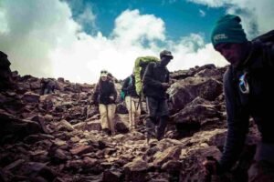 A rugged hiking trail traversing deep valley bogs and rocky ridges along the Kilembe Southern Circuit route in Uganda