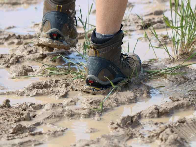 Waterproof hiking boots and tucked socks for gorilla trekking in Bwindi gorilla safari packing list